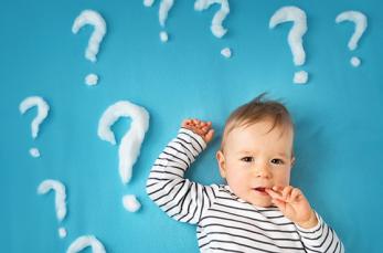 photo of a little boy surrounded by question marks